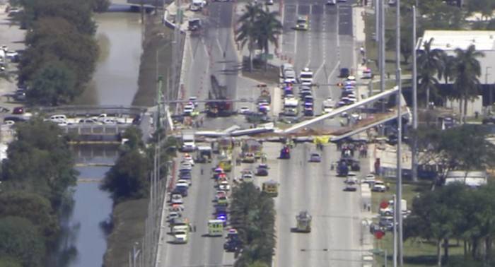 Pedestrian bridge collapses in Miami, people trapped underneath