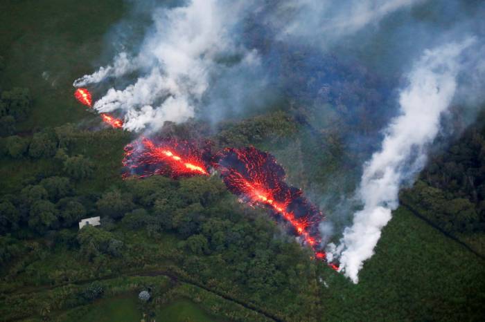 Hawaii volcano explosions shoot ash to 11,000ft as lava swamps road - NO COMMENT