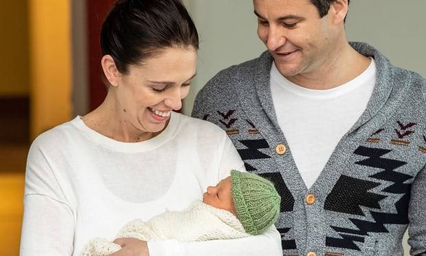 Jacinda Ardern welcomes new welfare reforms from the sofa with new baby