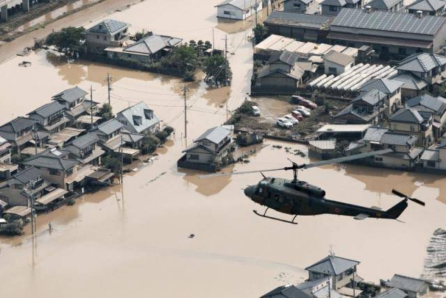 Japan hunts for survivors of floods that killed nearly 100
 