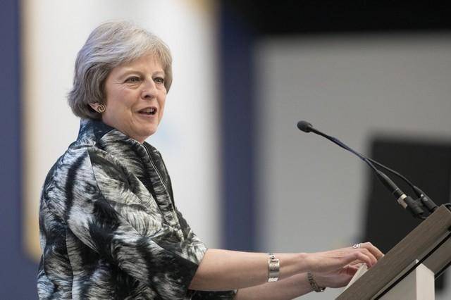 May narrowly avoids defeat in parliament on EU trade laws
 