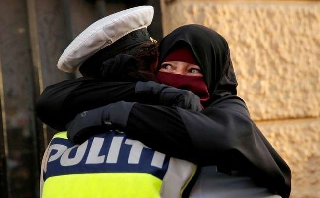 Danish police investigate officer who hugged niqab-wearing protester