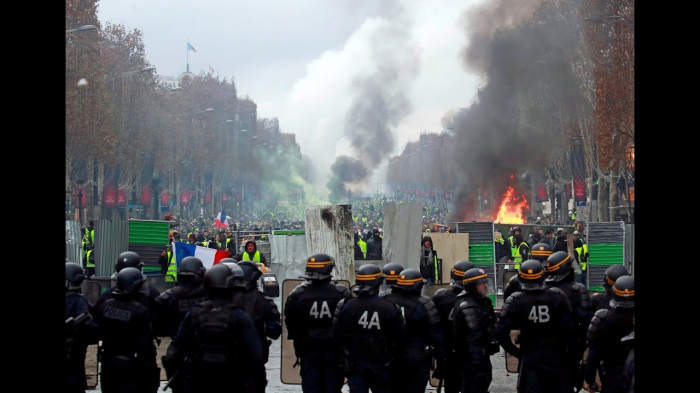 French police clash violently with protesters on Champs Elysees over petrol costs