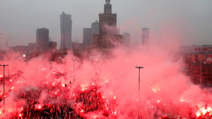 WATCH thousands of far-right marchers light a SEA OF FLARES in Poland as police look on -VIDEO