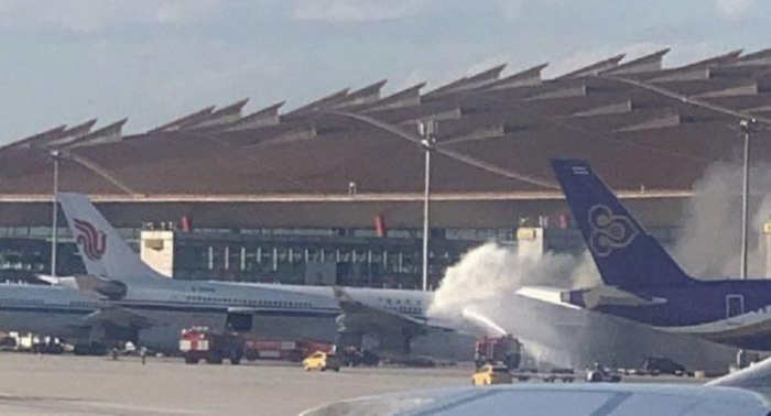 Passenger   plane catches fire   at Beijing airport