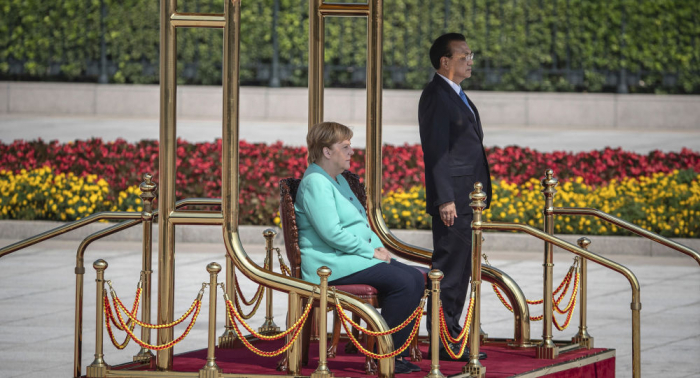 Angela Merkel sits for anthems during China visit