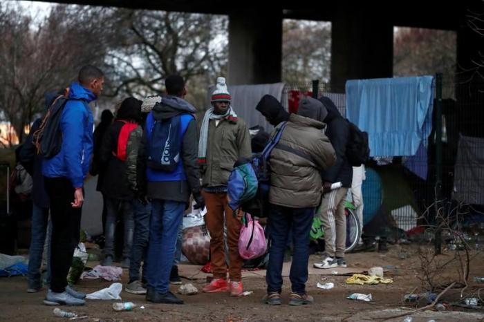 France says to clear some migrant camps by year-end