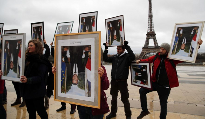  French climate activists hold stolen Macron portraits at protest-  NO COMMENT  