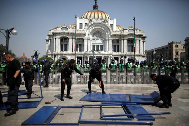 Mexican activists splash presidential palace red, protesting murder of women
