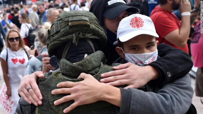   Belarus riot police   drop shields   and are embraced by anti-government protesters  