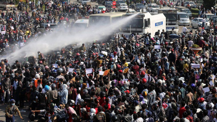 Myanmar police use water cannon as thousands protest