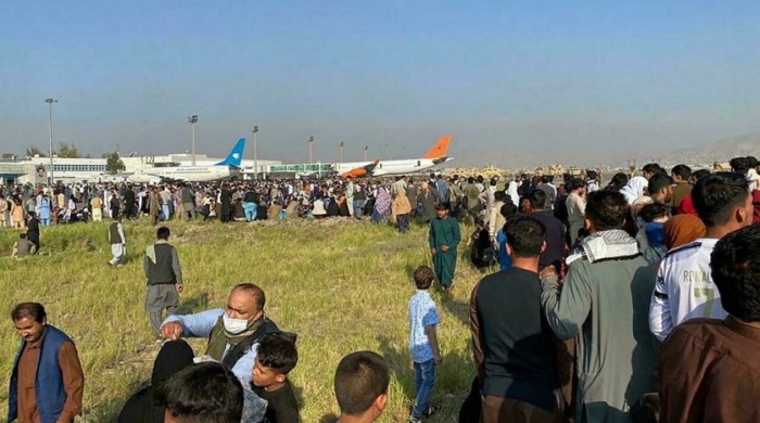   Chaos at Kabul airport as thousands flee Afghanistan after Taliban takeover -   VIDEO    