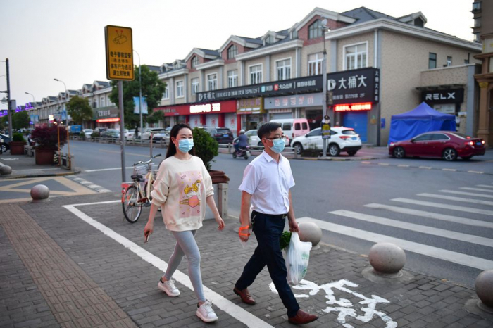 Some in Shanghai leave home for 1st time in two weeks as COVID curbs ease