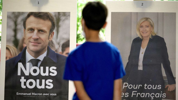 French vote as Macron aims to beat far-right Le Pen