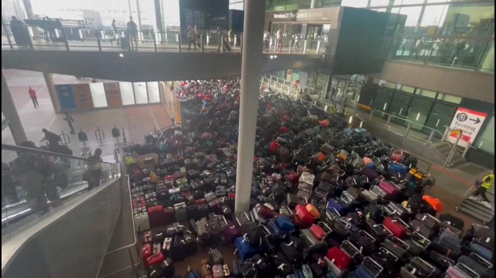   Piles of luggage carpet area of Heathrow Airport -   NO COMMENT    