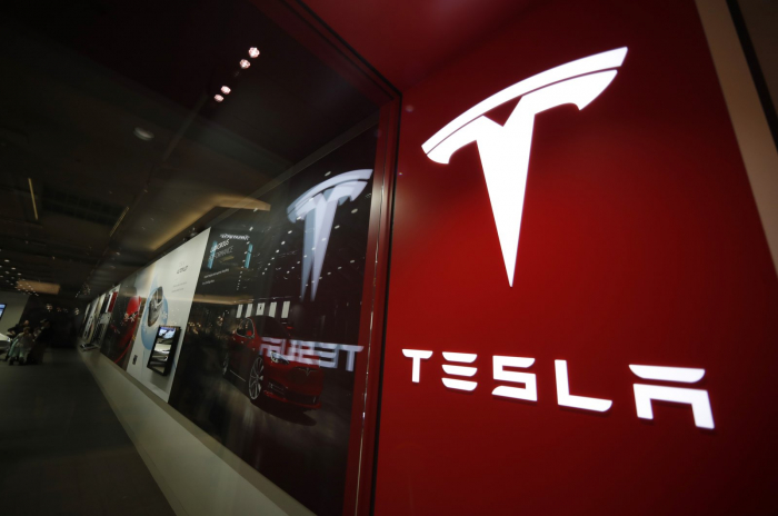 Tesla boosts auto prices, sells bitcoin