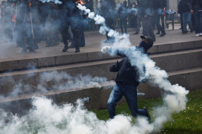 Paris police fire tear gas as French march against pension reform