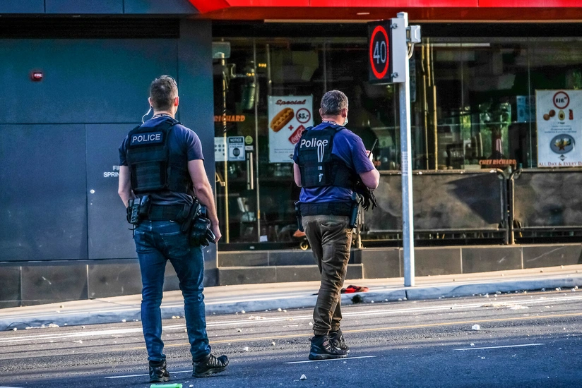 Man arrested after about 50 shots fired from Sydney flat into street, injuring 16