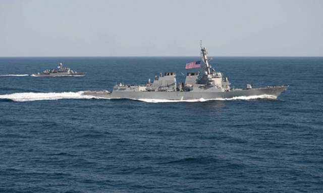 US warship defies Beijing to sail past disputed South China Sea islands