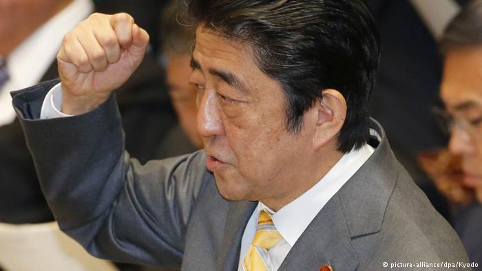 Japan`s Abe sticks to tax hike plans