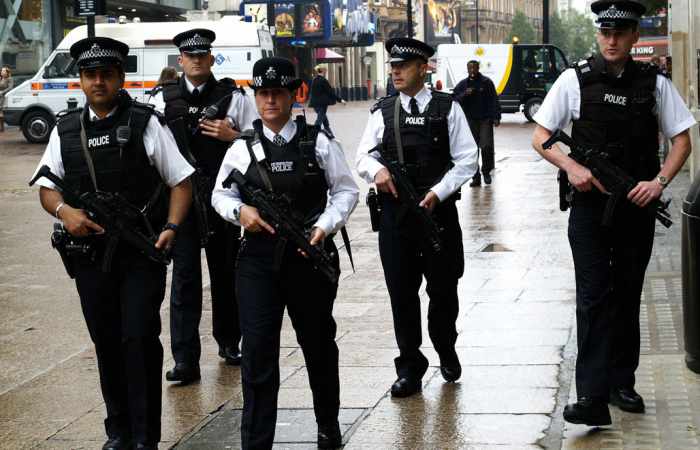 British police charge 13 people over attack on asylum seeker in London