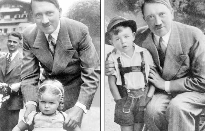 Adolf Hitler grins as he poses with children in propaganda photographs 