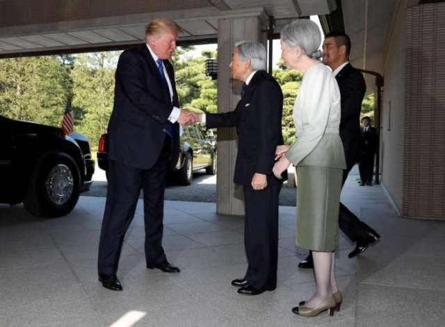 Trump greets Japanese emperor with a handshake and nod - but no bow