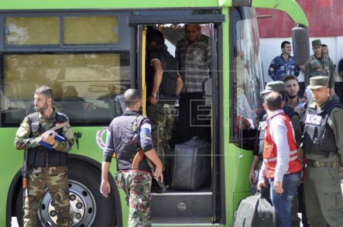 Un nuevo convoy de evacuados sale de la ciudad siria de Homs hacia una zona rebelde