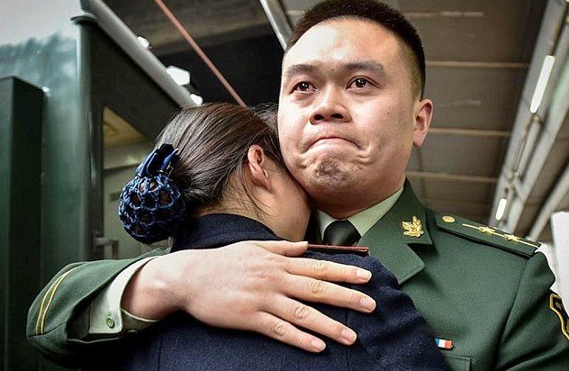 Chinese soldier and his train conducter wife celebrate a 30-minute honeymoon