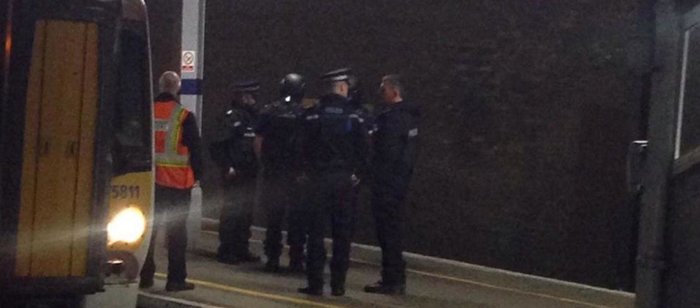 Armed police filmed storming a London-bound train with suspected killer on the loose