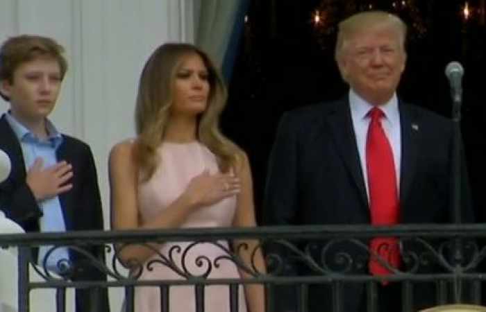 Melania appears to remind Trump to put hand on heart for national anthem - VIDEO
