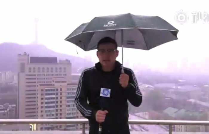 Chinese reporter struck by lightning during live broadcast - VIDEO